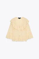 BLOUSE EN MAILLE POINTELLE À VOLANTS