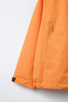 VESTE LÉGÈRE À CAPUCHE DÉPERLANTE