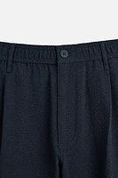 TEXTURED PLEATED PANTS