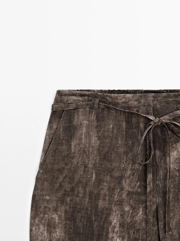 Distressed-effect flared trousers