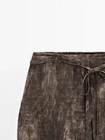 Distressed-effect flared trousers