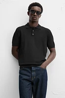 Knit polo shirt viscose blend fabric. Lapel collar with front button closure. Short sleeves. Side vents at hem. Rib trim.