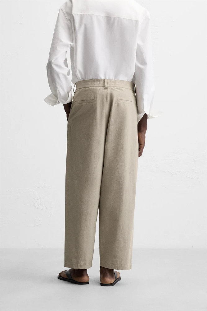 PLEATED CHINO PANTS