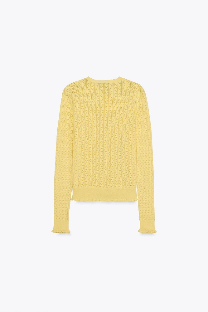 GILET EN MAILLE POINTELLE À VOLANTS