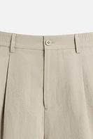 PLEATED CHINO PANTS