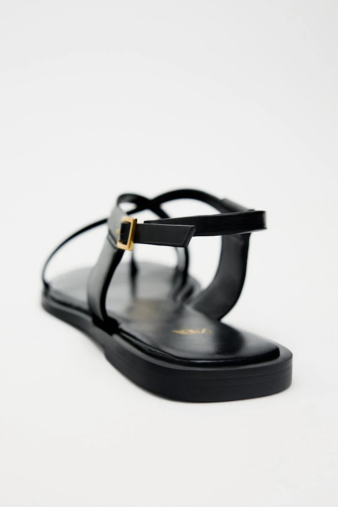 FLAT STRAPPY SANDALS WITH METAL ORNAMENT