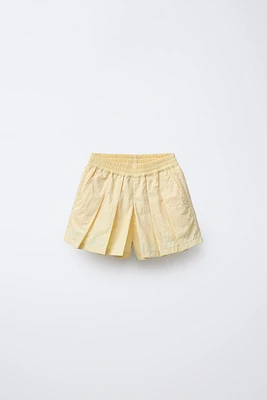 JUPE-SHORT TECHNIQUE À PLIS PLATS