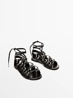 Lace-up sandals with rings