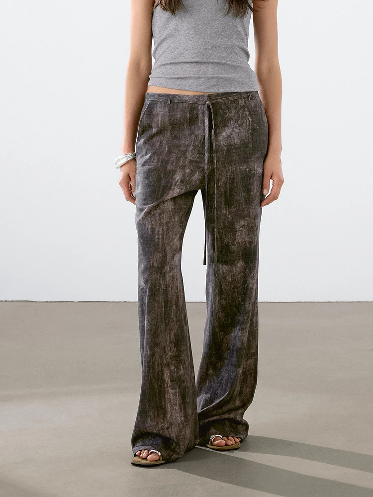 Distressed-effect flared trousers