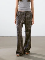 Distressed-effect flared trousers