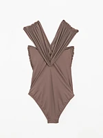 Bandeau swimsuit with criss-cross straps