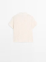 Polo en maille ajourée avec broderie