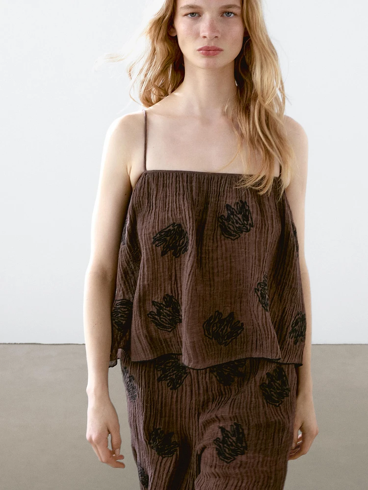Flowing textured top with embroidered detail