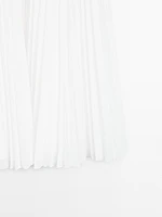 Pleated skirt with leather detail