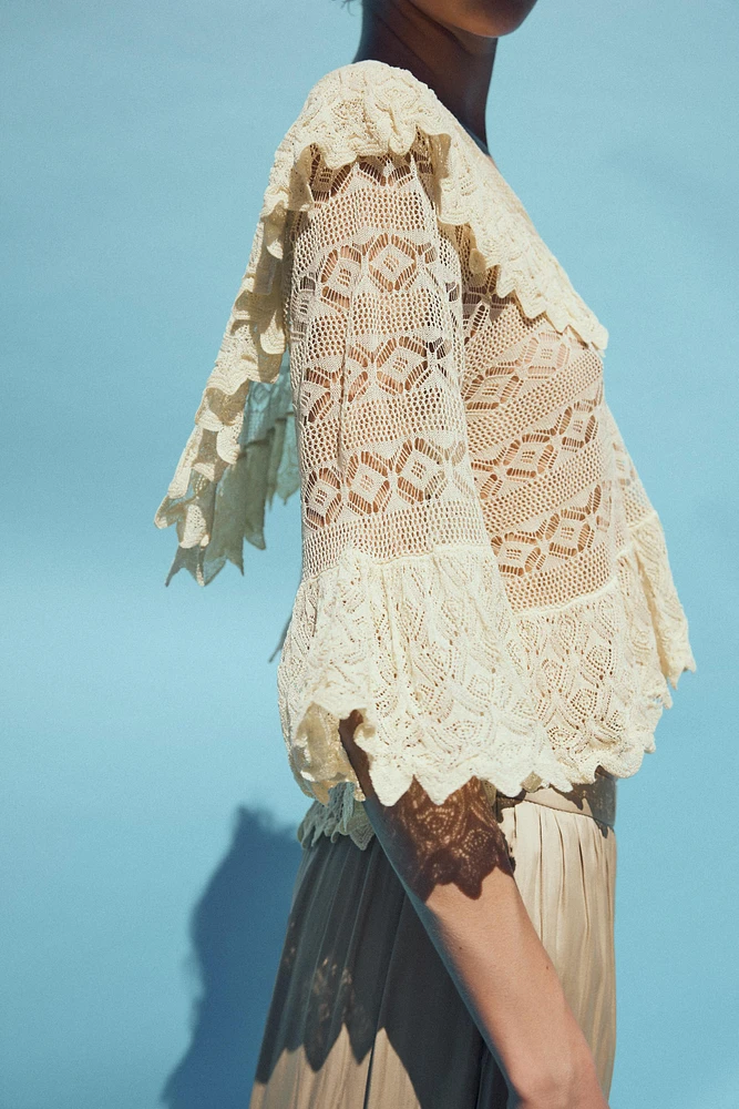 BLOUSE EN MAILLE POINTELLE À VOLANTS