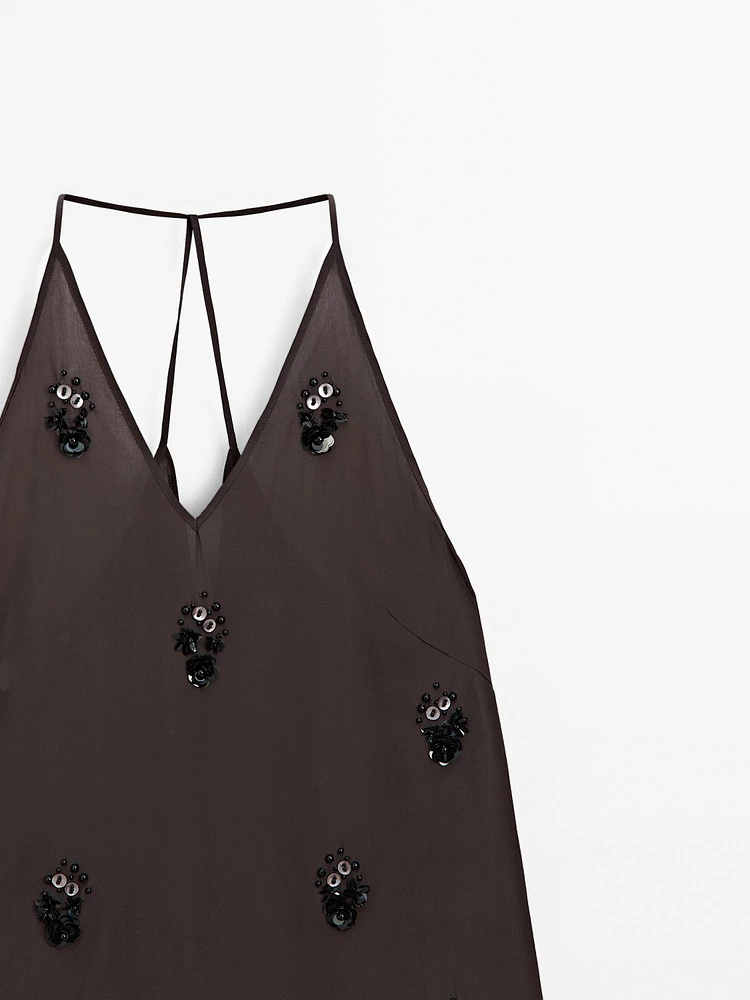 Flowing top with floral appliqués