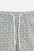 REGULAR FIT GEOMETRIC PRINT SWIM TRUNKS