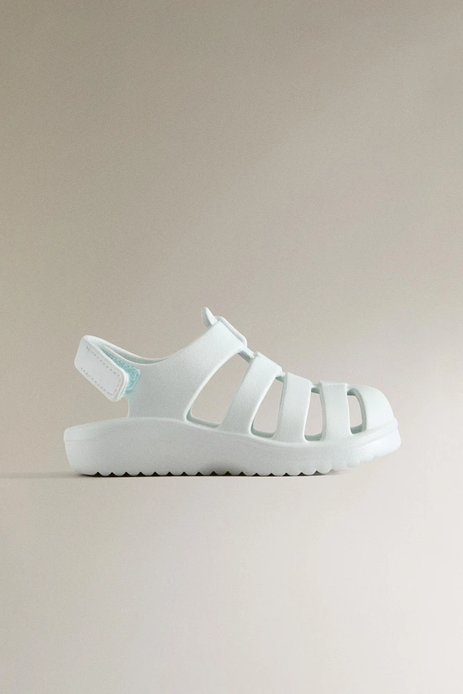 RUBBERIZED CAGE SANDALS WITH AN ADHESIVE STRAP
