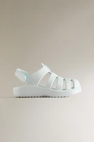 RUBBERIZED CAGE SANDALS WITH AN ADHESIVE STRAP