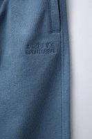 PANTALON DE JOGGING AVEC INSCRIPTION BRODÉE