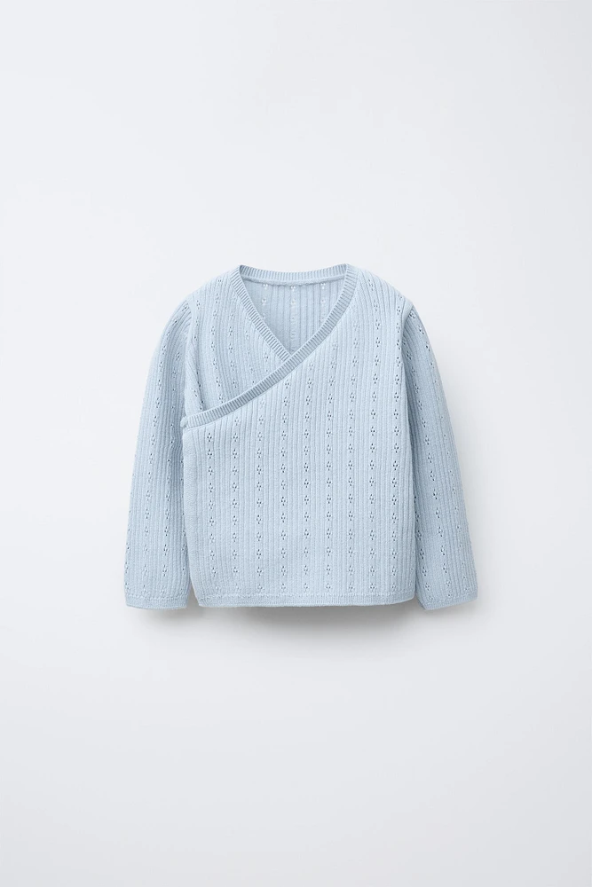 GILET EN MAILLE CROISÉ AJOURÉ
