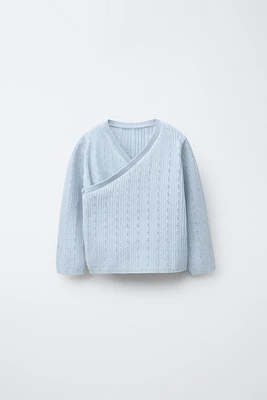 GILET EN MAILLE CROISÉ AJOURÉ