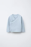 GILET EN MAILLE CROISÉ AJOURÉ