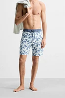 GEOMETRIC PRINT LONGLINE SWIMMING TRUNKS