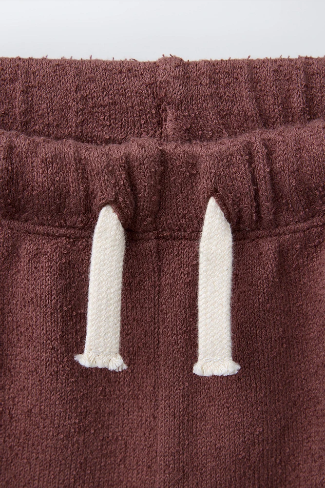 BERMUDA SERVIETTE BANDES LATÉRALES