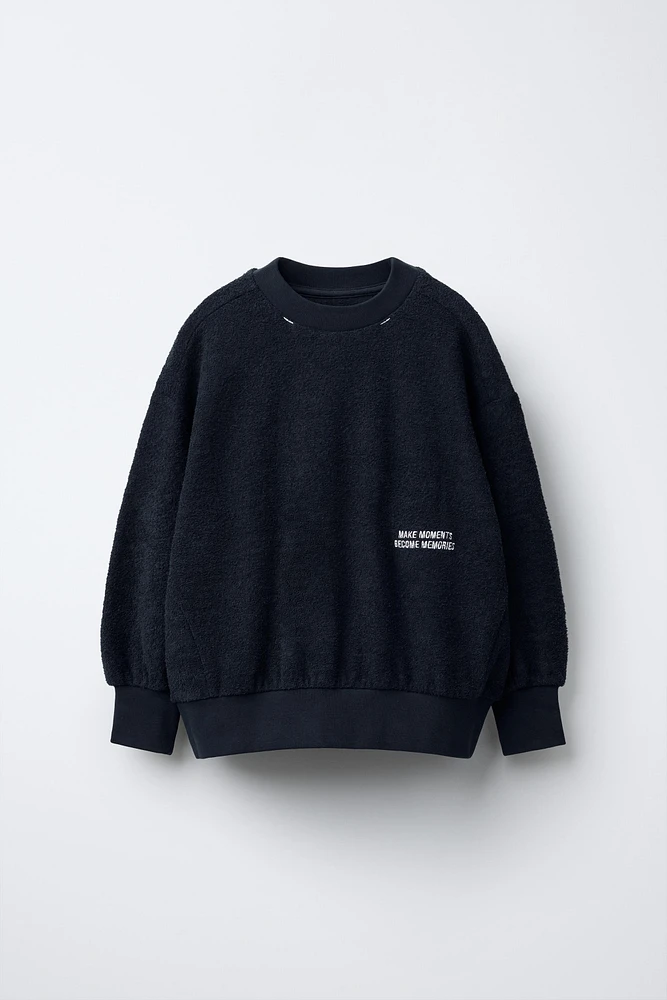 EMBROIDERED TEXT BOUCLÉ SWEATSHIRT