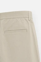 PLEATED CHINO PANTS