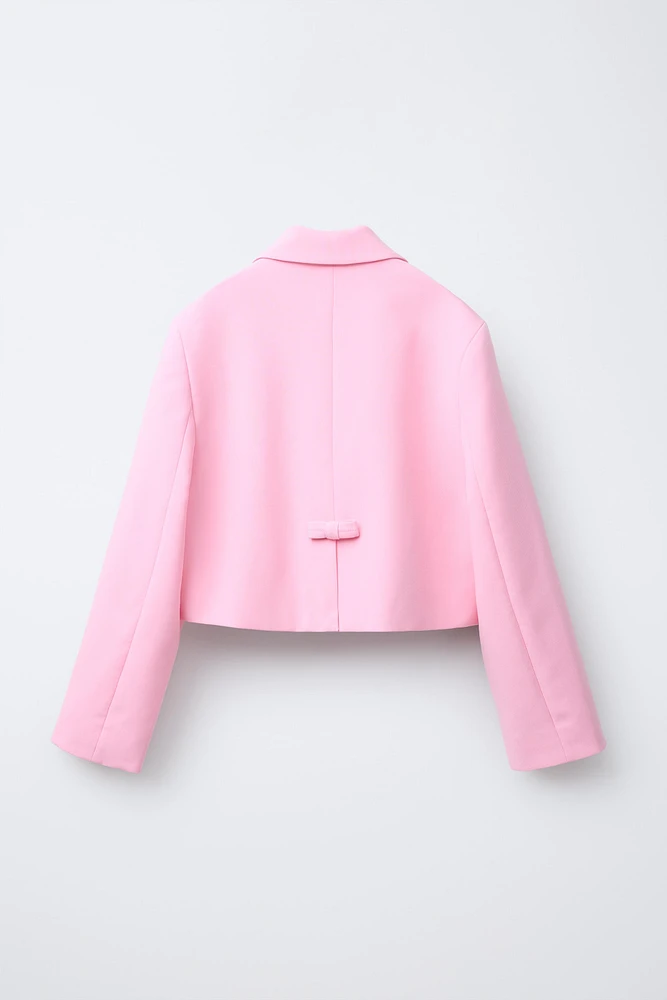 VESTE COURTE À NŒUDS