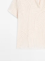 Polo en maille ajourée avec broderie