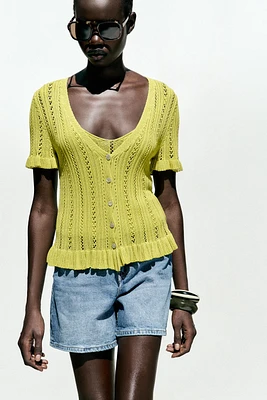 GILET EN MAILLE POINTELLE À VOLANTS