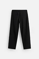 TEXTURED PLEATED PANTS