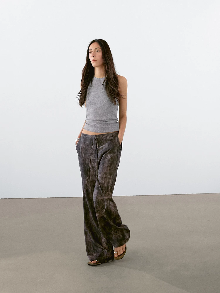 Distressed-effect flared trousers