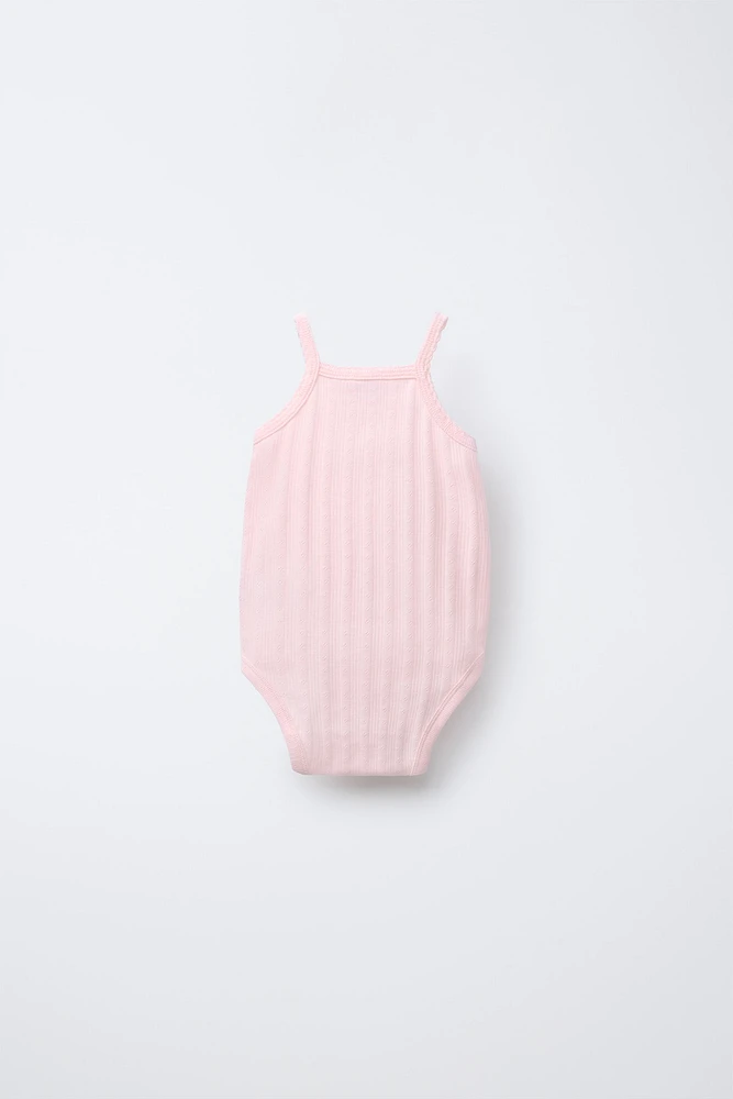 THREE-PACK OF RIB KNIT BODYSUITS WITH CUTOUT DETAIL