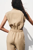 SLEEVELESS BELTED JUMPSUIT