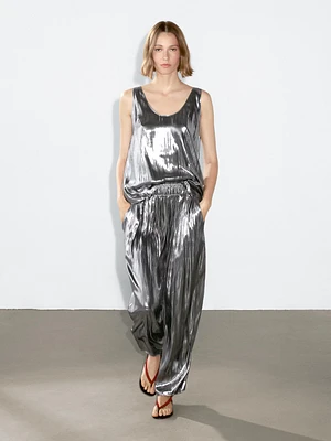 Flowing metallic trousers with gathered detail