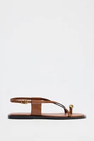 FLAT SANDALS WITH STRAPS AND METAL DETAIL