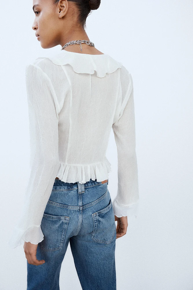 BLOUSE SEMI-TRANSPARENTE À VOLANTS