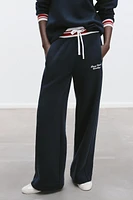 EMBROIDERED TEXT PANTS