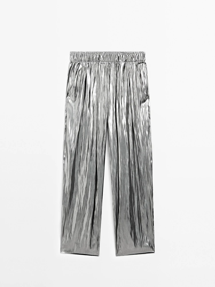 Flowing metallic trousers with gathered detail