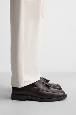 MOCASSINS CHICS À POMPONS