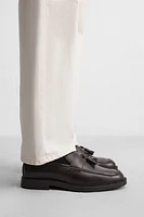 MOCASSINS CHICS À POMPONS