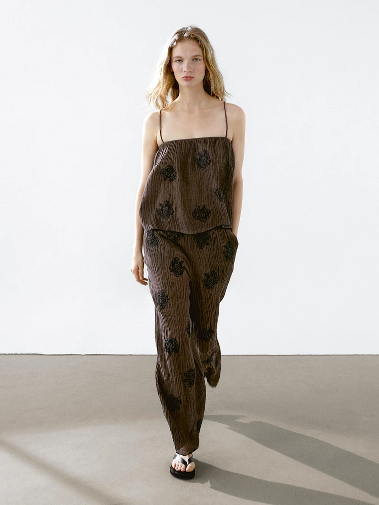 Flowing textured trousers with embroidered detail