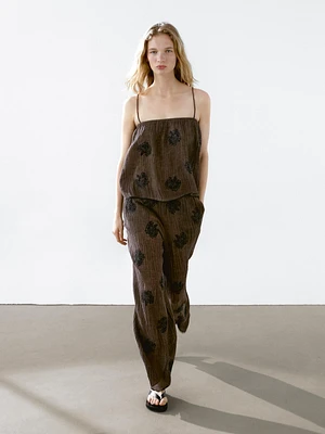Flowing textured trousers with embroidered detail