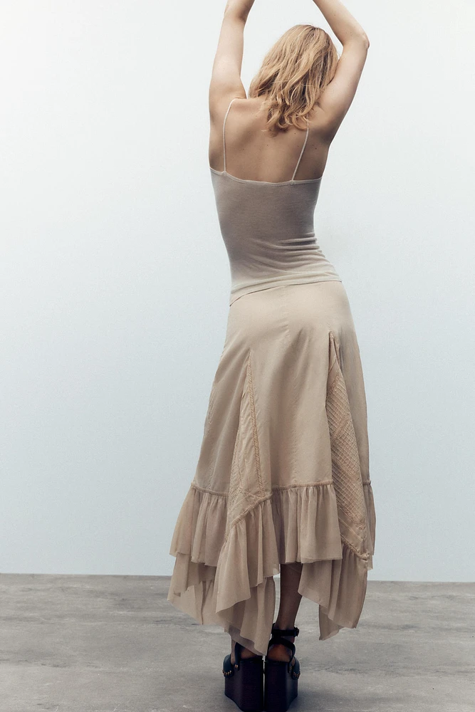 JUPE PLISSÉE ASYMÉTRIQUE