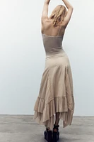 JUPE PLISSÉE ASYMÉTRIQUE