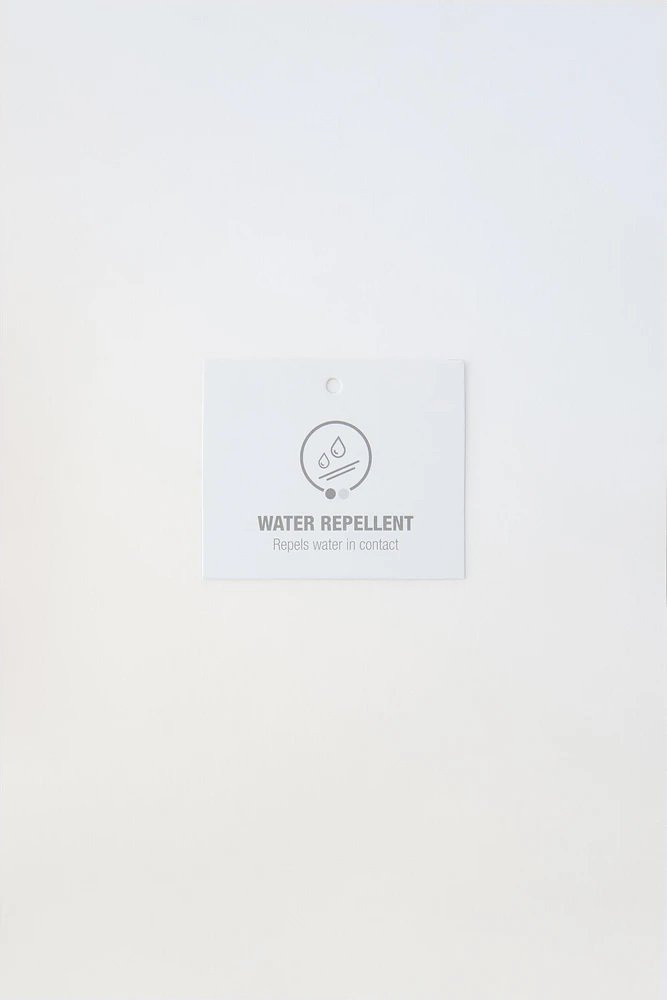 MANTEAU DÉPERLANT ÉTIQUETTE